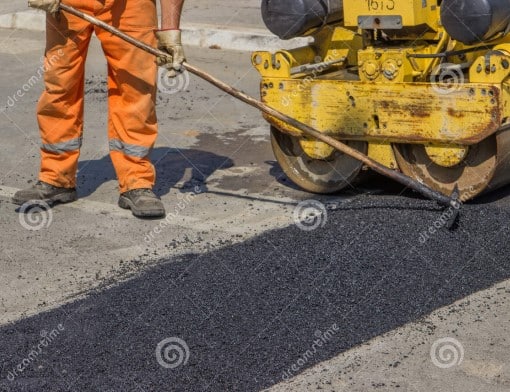 city-crew-install-new-speed-bump-slowing-traffic-near-school-selective-focus-44946180